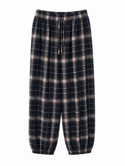 Delantero pantalón negro de cuadros escoceses con cintura y bajos elásticos.